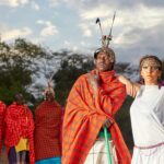 A group showcasing traditional Maasai attire against a vibrant Kenyan landscape.