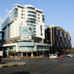 Street view of Gautrain Hotel and Radisson Blu in Johannesburg, capturing urban vibrancy.