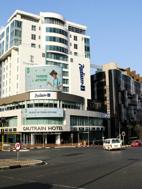 Street view of Gautrain Hotel and Radisson Blu in Johannesburg, capturing urban vibrancy.