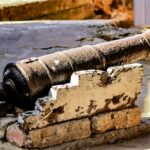 A weathered antique cannon displayed at historic Fort Jesus in Mombasa, Kenya.