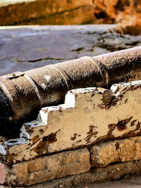 A weathered antique cannon displayed at historic Fort Jesus in Mombasa, Kenya.